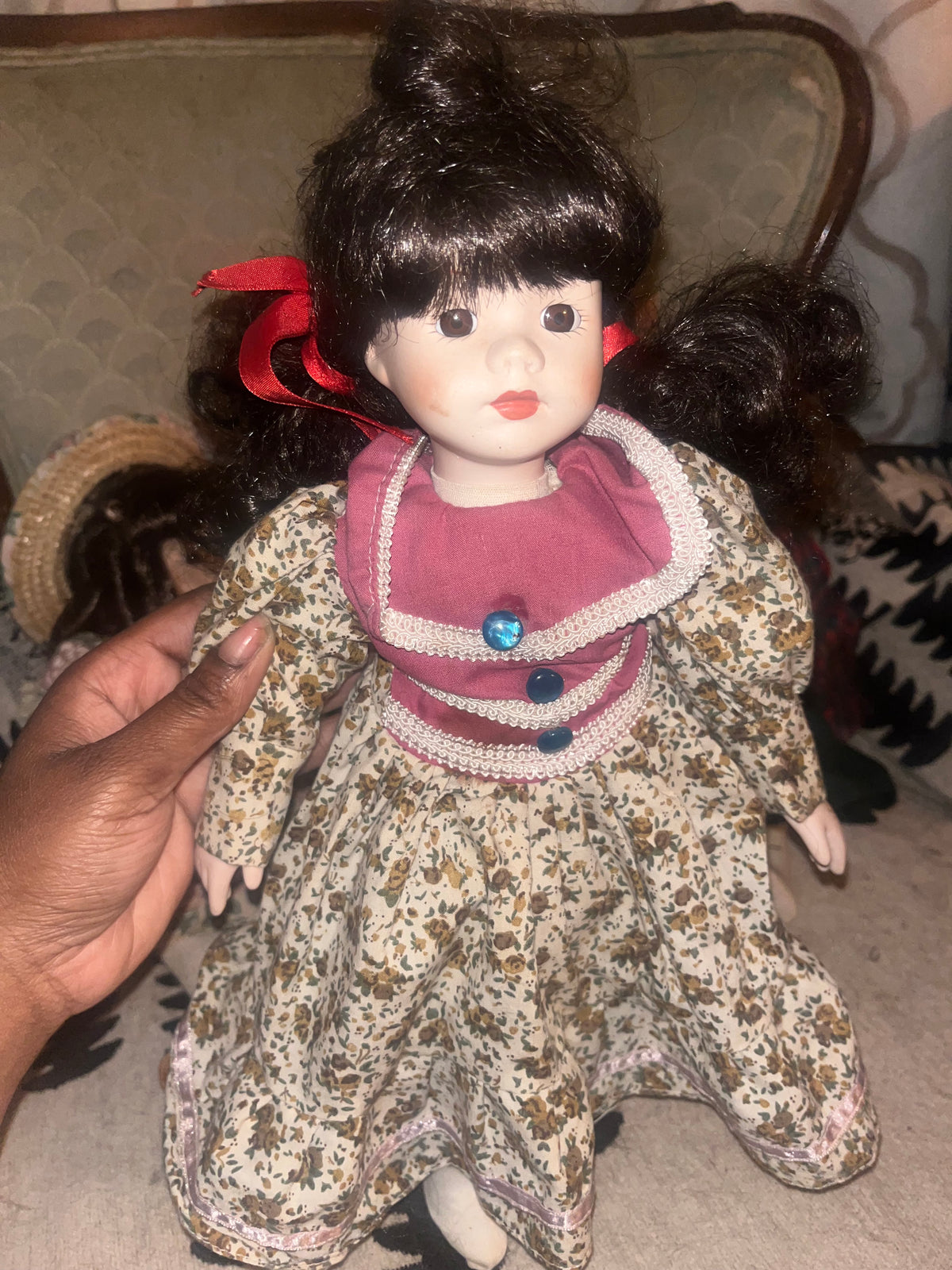Vintage Porcelain Doll in Floral Dress with Red Ribbon Pigtails